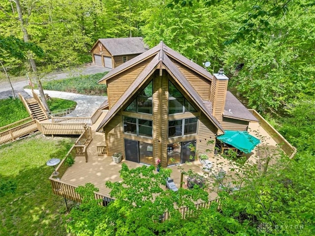 10370 Old 3c Hwy, Clarksville, OH 45113 - rear view of house with a deck, a chimney, a forest view, stairway, and a garage