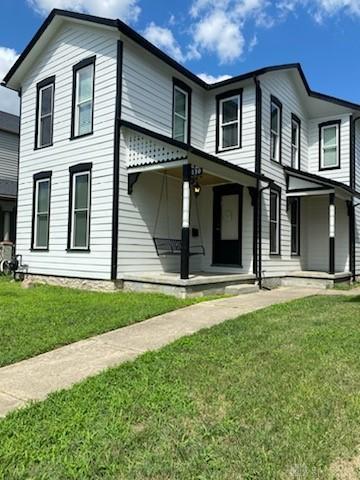 130 Mound St, Dayton, OH 45402 - view of front facade featuring covered porch and a front lawn