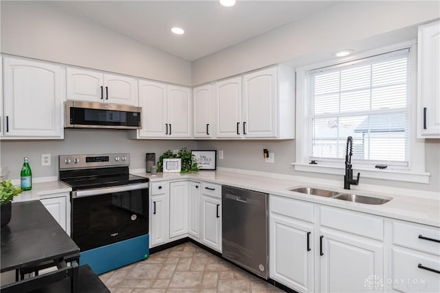 130 Mound St, Dayton, OH 45402 - kitchen with appliances with stainless steel finishes, white cabinetry, recessed lighting, and light countertops