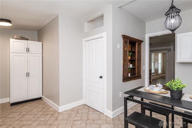 130 Mound St, Dayton, OH 45402 - corridor featuring stone finish flooring and a chandelier