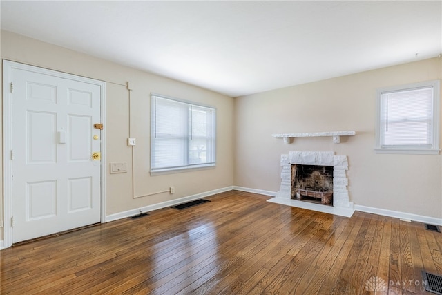 349 E Xenia Dr, Fairborn, OH 45324 - unfurnished living room featuring a fireplace with flush hearth and wood-type flooring