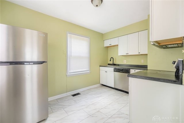 349 E Xenia Dr, Fairborn, OH 45324 - kitchen with appliances with stainless steel finishes, dark countertops, light marble finish floors, and white cabinetry