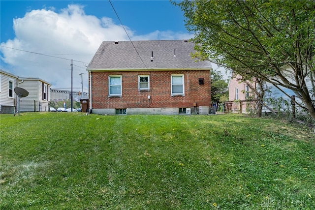 349 E Xenia Dr, Fairborn, OH 45324 - back of property featuring a shingled roof, a lawn, and brick siding