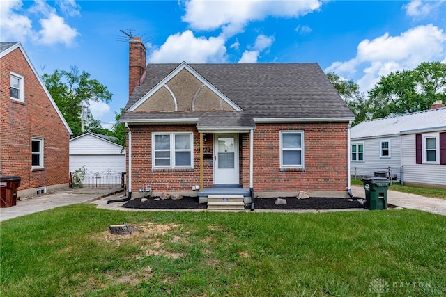 349 E Xenia Dr, Fairborn, OH 45324 - view of front of property featuring brick siding, a front lawn, a chimney, and a shingled roof