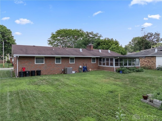 670 Saxony Dr, Xenia, OH 45385 - rear view of property with brick siding, a sunroom, and a chimney