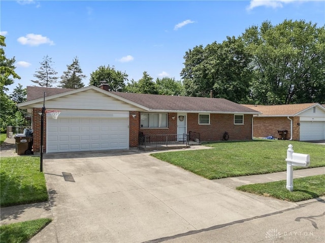 670 Saxony Dr, Xenia, OH 45385 - single story home featuring driveway, a garage, brick siding, and a front yard
