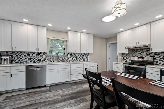 670 Saxony Dr, Xenia, OH 45385 - kitchen with stainless steel appliances, backsplash, white cabinets, under cabinet range hood, and recessed lighting