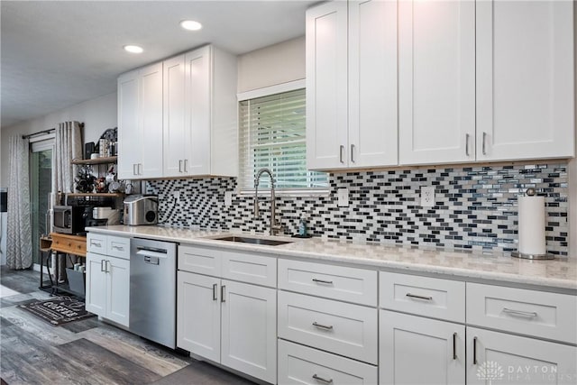 670 Saxony Dr, Xenia, OH 45385 - kitchen with stainless steel dishwasher, wood finished floors, white cabinets, open shelves, and tasteful backsplash