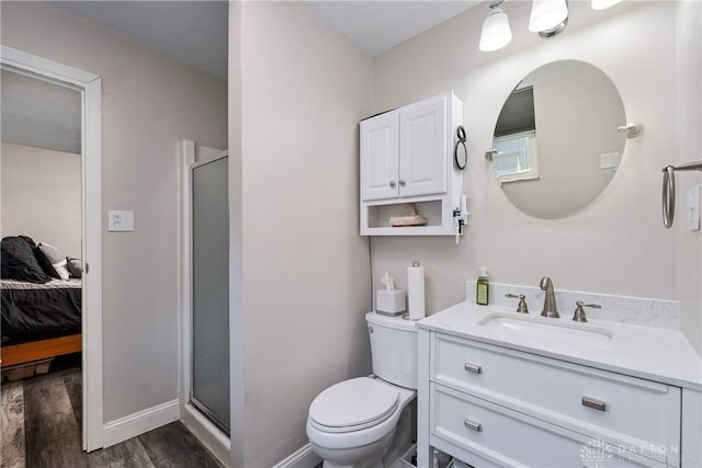 670 Saxony Dr, Xenia, OH 45385 - bathroom featuring connected bathroom, a shower stall, wood finished floors, and vanity