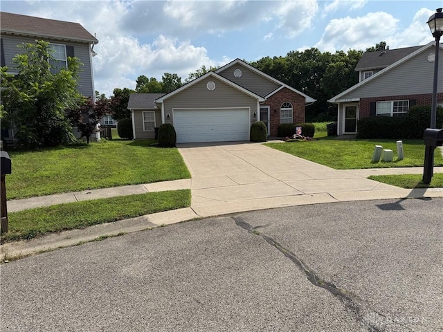 3509 Brian Ct, Middletown, OH 45044 - view of front of property with a front lawn, concrete driveway, a garage, and brick siding