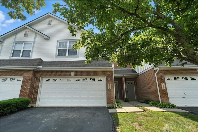 9266 Great Lakes Cir, Washington Twp, OH 45458 - traditional home with driveway, brick siding, and an attached garage