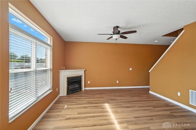 9266 Great Lakes Cir, Washington Twp, OH 45458 - unfurnished living room with light wood-type flooring, ceiling fan, and a fireplace