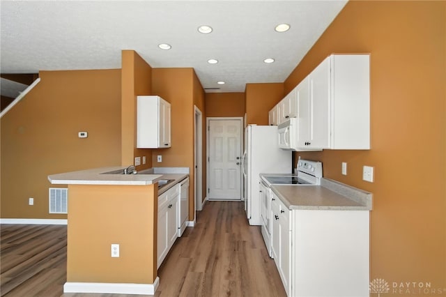 9266 Great Lakes Cir, Washington Twp, OH 45458 - kitchen featuring white appliances, light wood-style floors, white cabinets, a peninsula, and recessed lighting