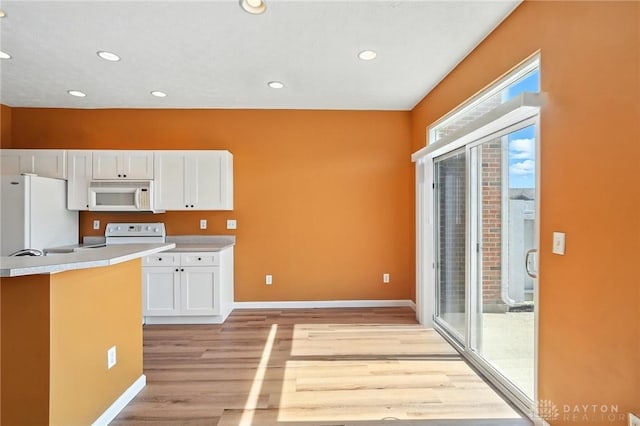 9266 Great Lakes Cir, Washington Twp, OH 45458 - kitchen with white appliances, white cabinetry, light wood finished floors, light countertops, and recessed lighting