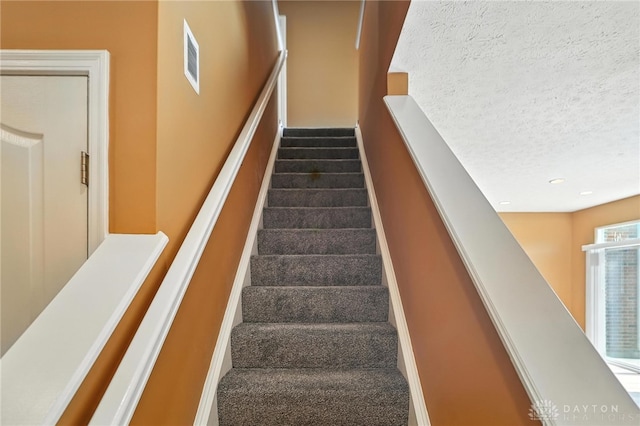 9266 Great Lakes Cir, Washington Twp, OH 45458 - stairs featuring carpet flooring, recessed lighting, and a textured ceiling
