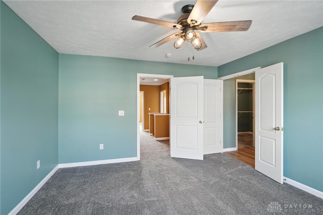 9266 Great Lakes Cir, Washington Twp, OH 45458 - unfurnished bedroom featuring carpet, a spacious closet, and ceiling fan