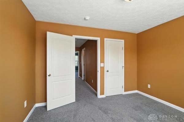 9266 Great Lakes Cir, Washington Twp, OH 45458 - unfurnished bedroom featuring dark carpet