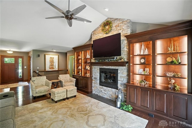 95 Sycamore Creek Dr, Springboro, OH 45066 - living area with dark wood finished floors, ceiling fan, a stone fireplace, and high vaulted ceiling