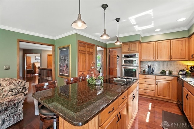 95 Sycamore Creek Dr, Springboro, OH 45066 - kitchen with black appliances, wood finished floors, tasteful backsplash, a breakfast bar, and crown molding