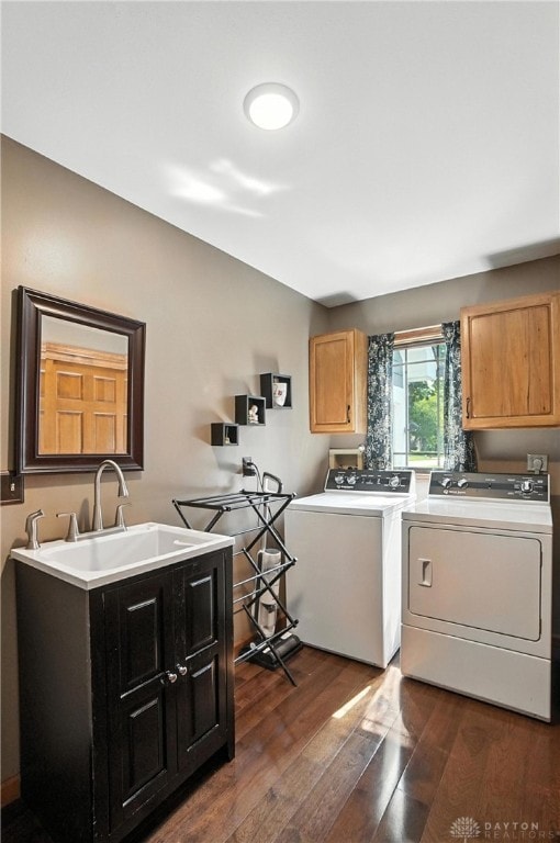 95 Sycamore Creek Dr, Springboro, OH 45066 - washroom featuring washer and clothes dryer, cabinet space, and dark wood-type flooring