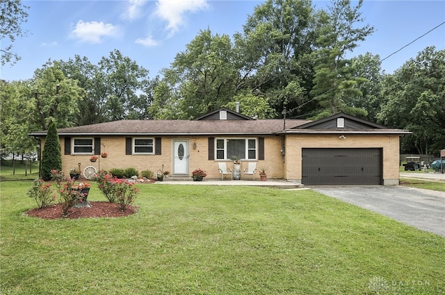 3755 Everett Dr, Loveland, OH 45140 - ranch-style house with driveway, a front yard, an attached garage, and brick siding