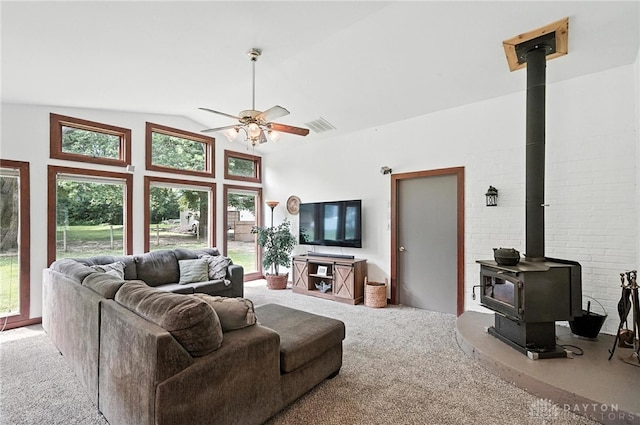3755 Everett Dr, Loveland, OH 45140 - carpeted living room featuring a wood stove, healthy amount of natural light, ceiling fan, and high vaulted ceiling