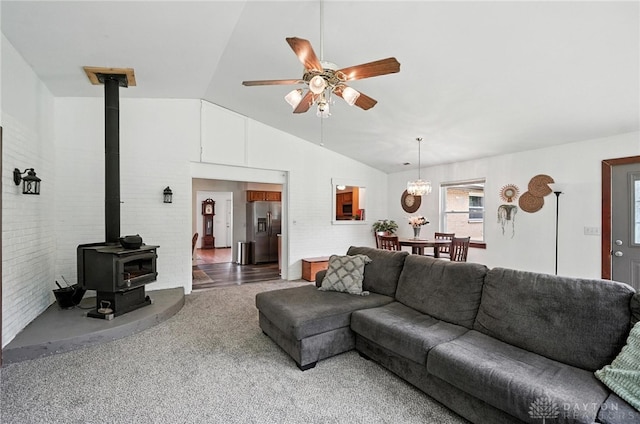3755 Everett Dr, Loveland, OH 45140 - carpeted living area featuring vaulted ceiling, a ceiling fan, and a wood stove