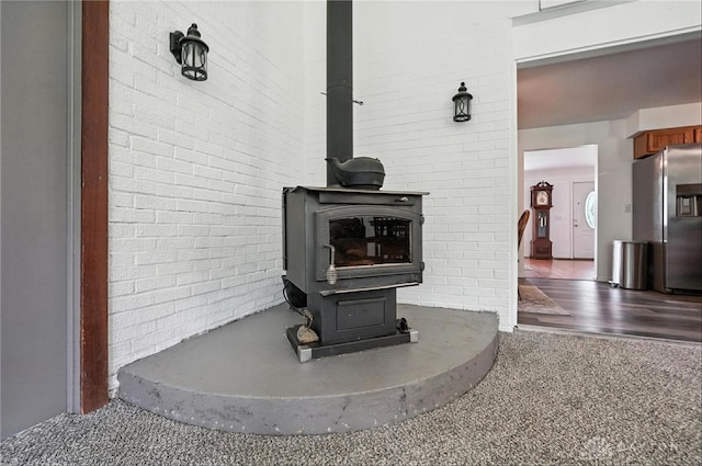 3755 Everett Dr, Loveland, OH 45140 - detailed view of a wood stove, stainless steel fridge with ice dispenser, and brick wall