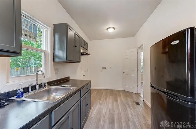 233 Alton Ave, Dayton, OH 45404 - kitchen featuring freestanding refrigerator, light wood-type flooring, dark countertops, and gray cabinetry