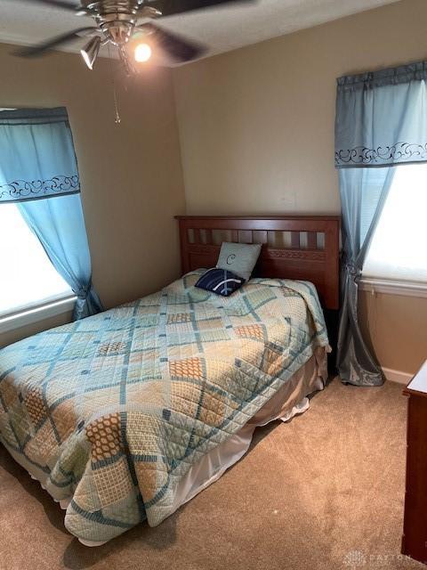 8120 Lawrence Dr, West Chester, OH 45069 - carpeted bedroom with ceiling fan and baseboards