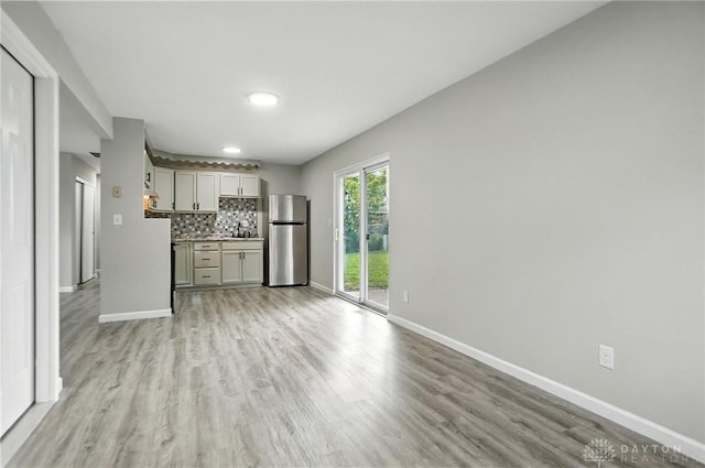 1393 Seminole Dr, Xenia, OH 45385 - unfurnished living room with a dry bar and light wood-style flooring