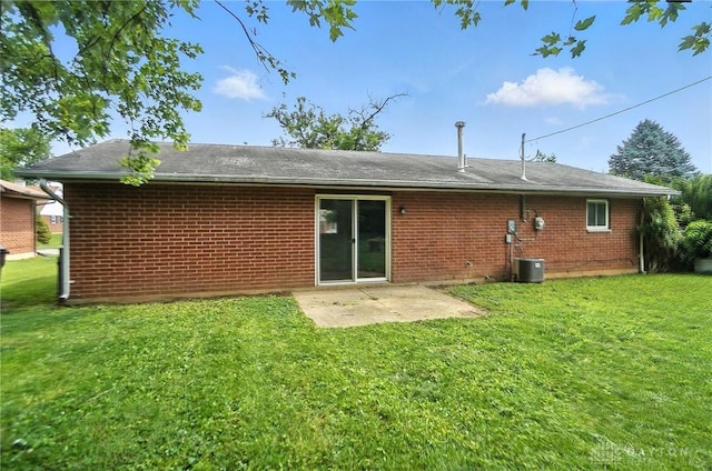 1393 Seminole Dr, Xenia, OH 45385 - rear view of property with brick siding, a lawn, and a patio area