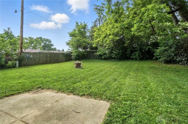 1393 Seminole Dr, Xenia, OH 45385 - fenced backyard with a fire pit and a patio area