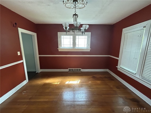 725 Sunnyview Ave, Dayton, OH 45406 - unfurnished dining area with a chandelier and wood finished floors