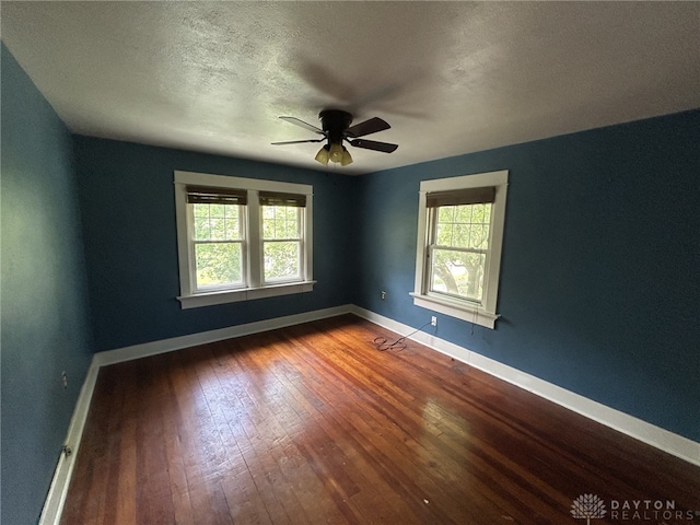 725 Sunnyview Ave, Dayton, OH 45406 - spare room featuring healthy amount of natural light, hardwood / wood-style floors, ceiling fan, and a textured ceiling