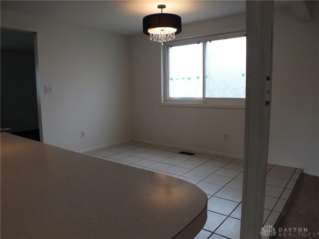 5582 Camerford Dr, Dayton, OH 45424 - unfurnished room featuring a chandelier and light tile patterned floors
