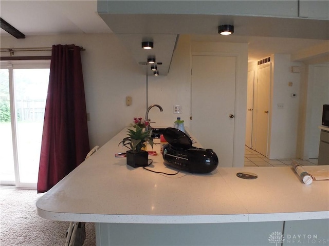 5582 Camerford Dr, Dayton, OH 45424 - kitchen featuring plenty of natural light, light countertops, and light colored carpet