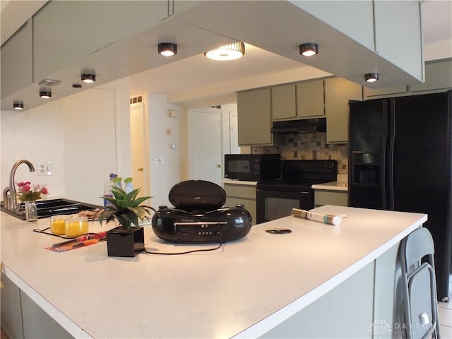 5582 Camerford Dr, Dayton, OH 45424 - kitchen featuring black appliances, under cabinet range hood, tasteful backsplash, and light countertops