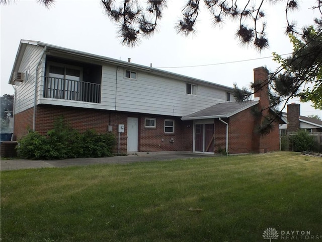 5582 Camerford Dr, Dayton, OH 45424 - rear view of house with brick siding, a yard, an attached carport, and a patio