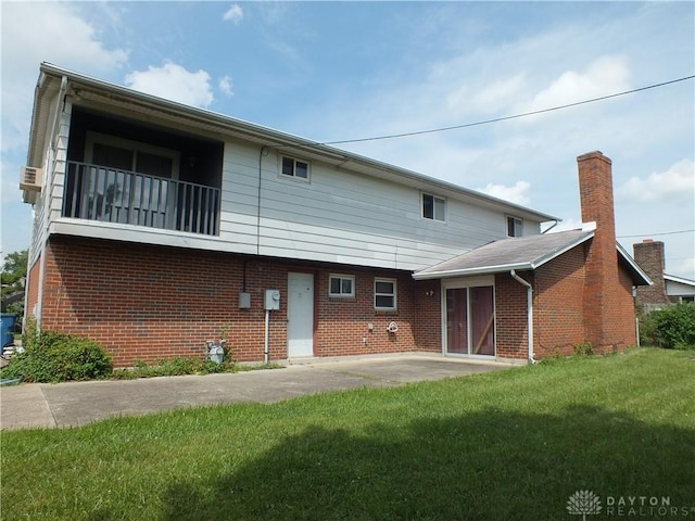 5582 Camerford Dr, Dayton, OH 45424 - rear view of house featuring brick siding, a yard, and a patio