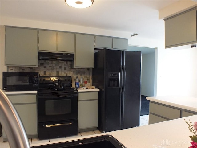5582 Camerford Dr, Dayton, OH 45424 - kitchen with black appliances, under cabinet range hood, gray cabinets, backsplash, and light countertops