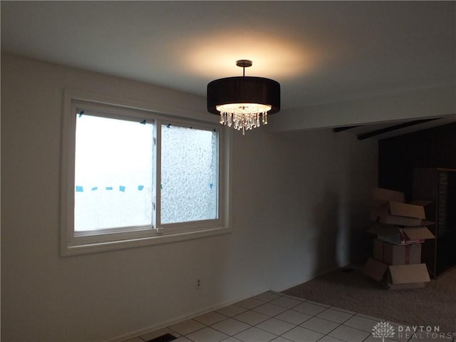 5582 Camerford Dr, Dayton, OH 45424 - unfurnished dining area featuring healthy amount of natural light, light tile patterned floors, and a chandelier