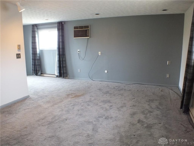 5582 Camerford Dr, Dayton, OH 45424 - carpeted spare room featuring a textured ceiling and a wall mounted air conditioner