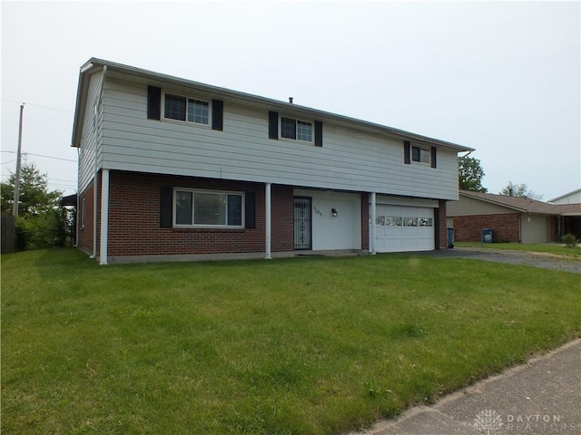 5582 Camerford Dr, Dayton, OH 45424 - colonial home featuring brick siding, driveway, a front yard, and a garage