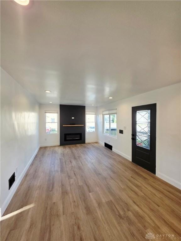 21 Anderson St, Dayton, OH 45410 - unfurnished living room with light wood finished floors, a fireplace, and recessed lighting