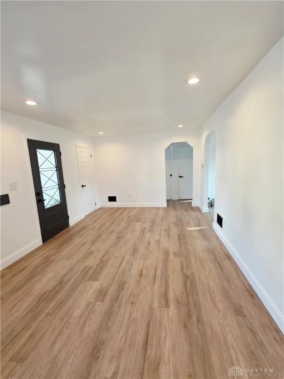 21 Anderson St, Dayton, OH 45410 - unfurnished living room with arched walkways, light wood-style flooring, and recessed lighting