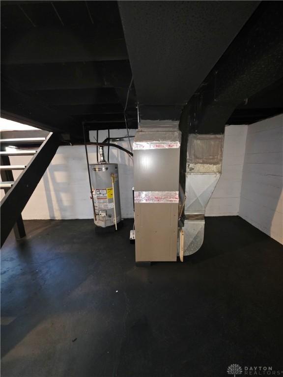 21 Anderson St, Dayton, OH 45410 - unfinished basement featuring gas water heater, stairway, and heating unit