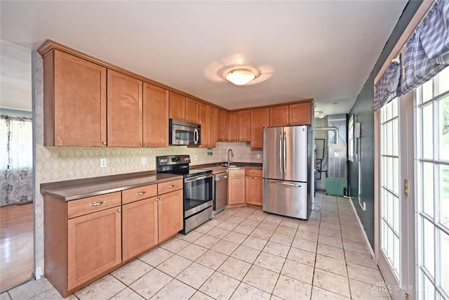 405 Parsons Ct, Englewood, OH 45322 - kitchen featuring stainless steel appliances, decorative backsplash, dark countertops, and light tile patterned flooring