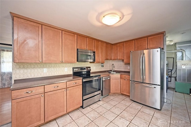 405 Parsons Ct, Englewood, OH 45322 - kitchen with appliances with stainless steel finishes, dark countertops, backsplash, and light tile patterned flooring