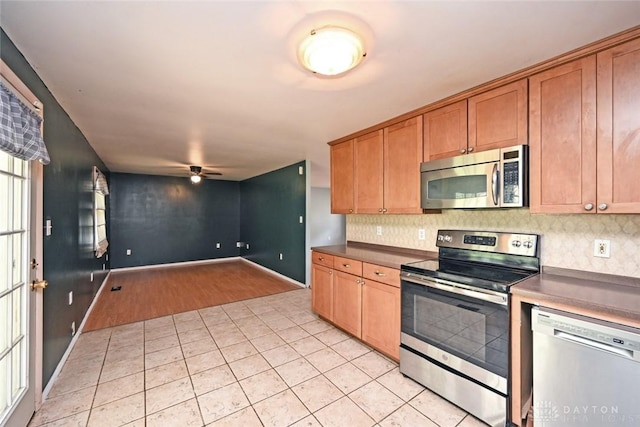 405 Parsons Ct, Englewood, OH 45322 - kitchen featuring stainless steel appliances, light tile patterned flooring, decorative backsplash, and ceiling fan